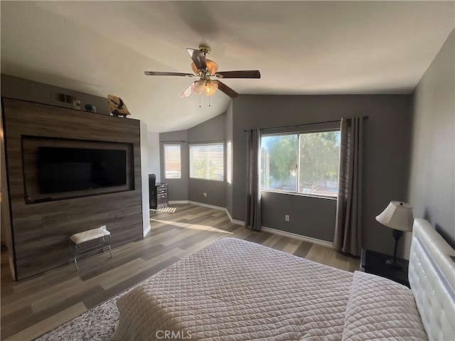 bedroom featuring hardwood / wood-style flooring, ceiling fan, and vaulted ceiling