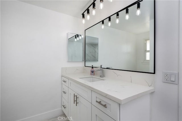 bathroom featuring baseboards and vanity