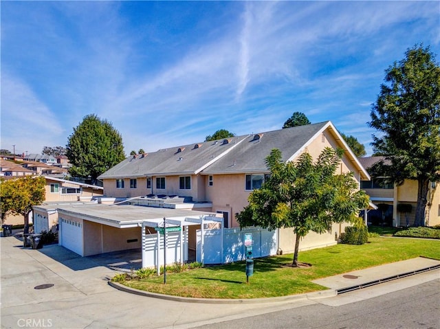 view of front of property with a front lawn and a garage