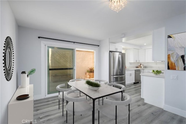 dining space with light hardwood / wood-style floors