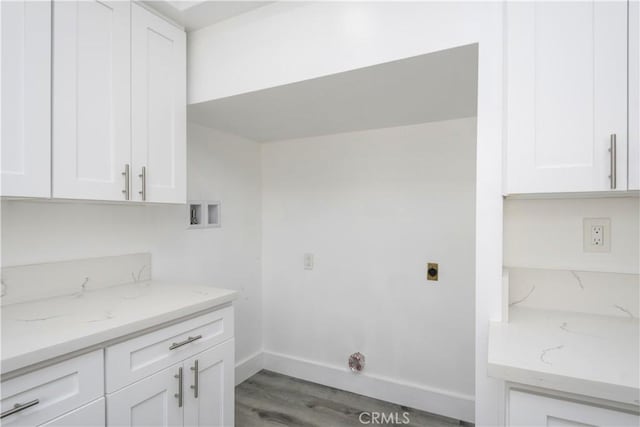 washroom featuring washer hookup, electric dryer hookup, cabinets, and light wood-type flooring