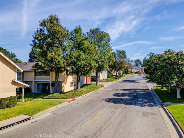 view of street with curbs and a residential view