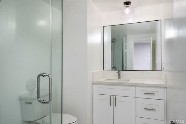 full bathroom with toilet, a shower stall, and vanity