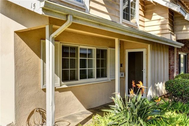 entrance to property featuring stucco siding