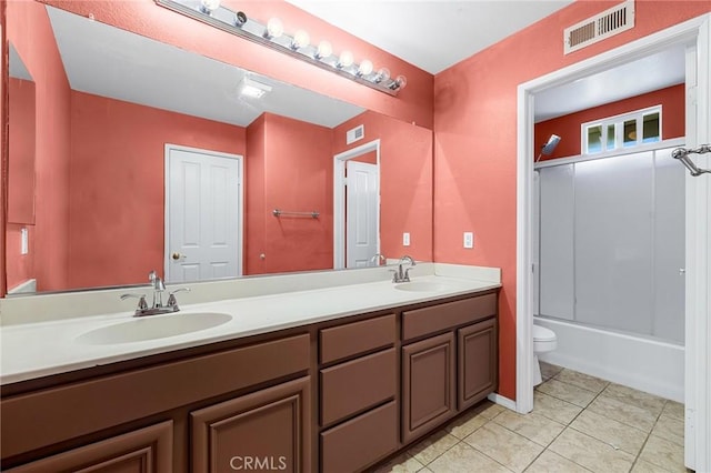 full bathroom with tile patterned flooring, vanity, toilet, and combined bath / shower with glass door