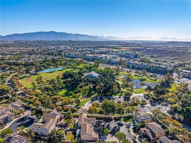 birds eye view of property with a water and mountain view