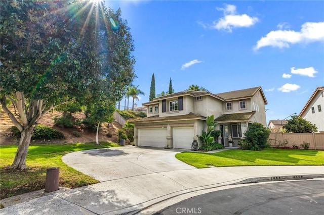 view of property with a garage and a front yard