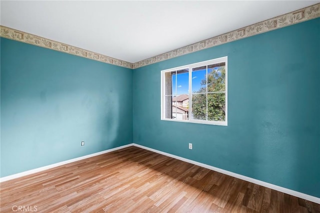 unfurnished room featuring hardwood / wood-style floors