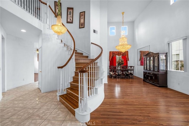 entrance foyer with a chandelier, a high ceiling, and light hardwood / wood-style flooring