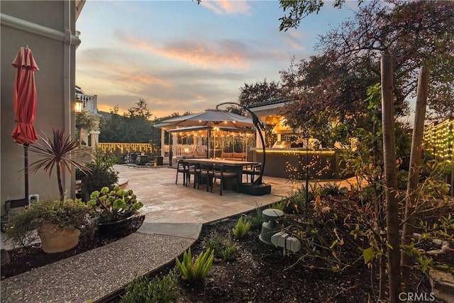 view of patio terrace at dusk