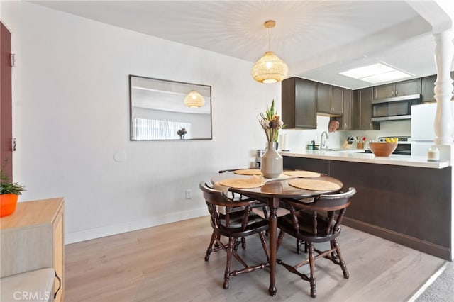 dining space featuring sink and light hardwood / wood-style flooring