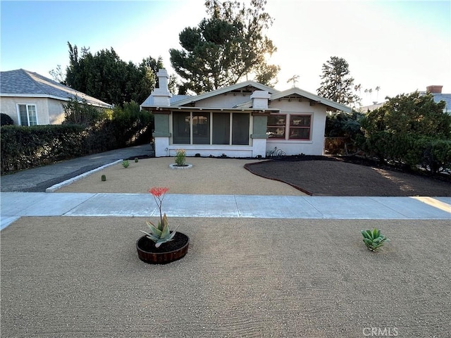 view of front of property with a sunroom and stucco siding