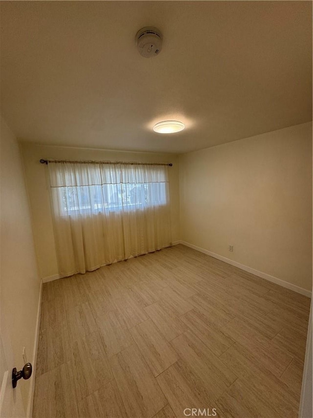 unfurnished room with hardwood / wood-style flooring