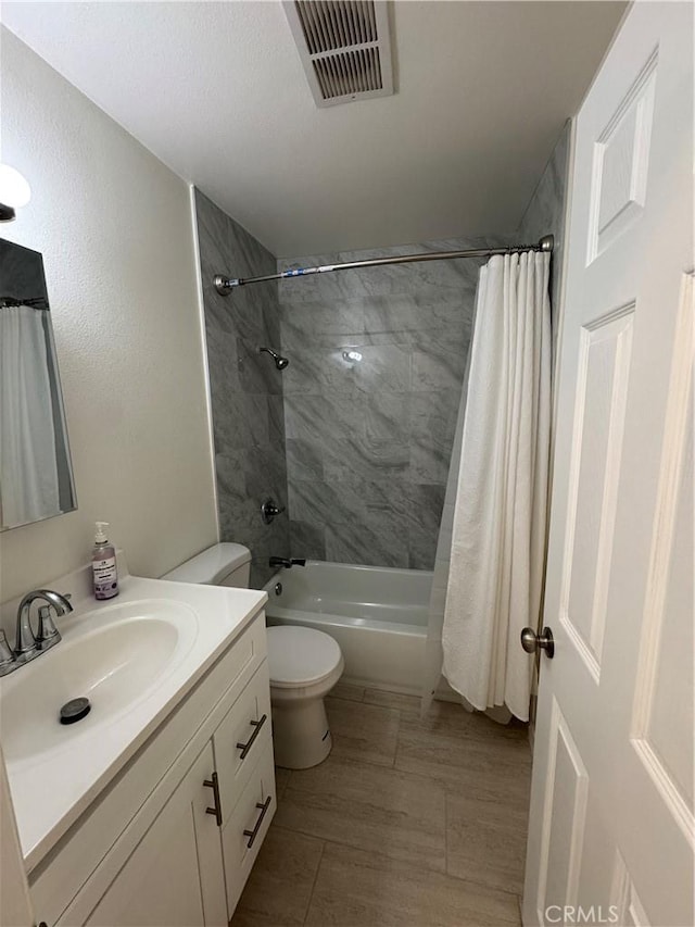 full bathroom featuring toilet, vanity, and shower / tub combo with curtain