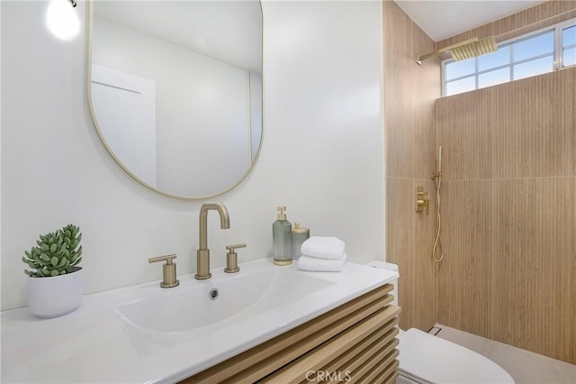 bathroom featuring vanity, toilet, and a shower