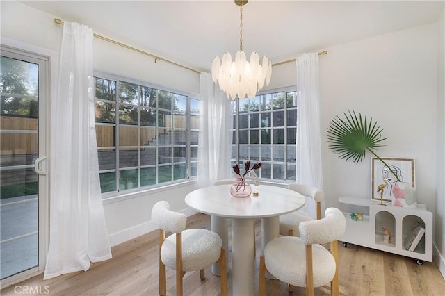 dining area featuring a notable chandelier and light hardwood / wood-style floors