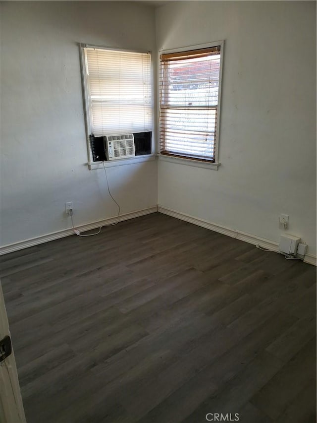 spare room with cooling unit and dark hardwood / wood-style floors