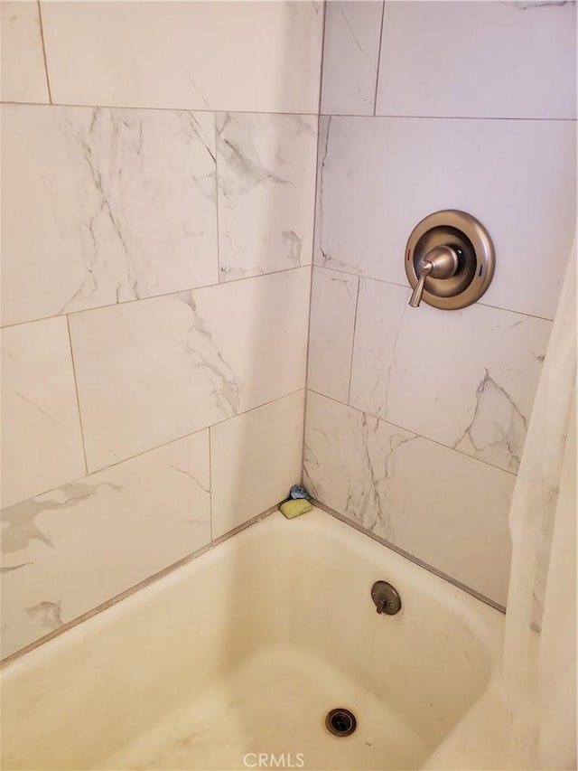 bathroom with tiled shower