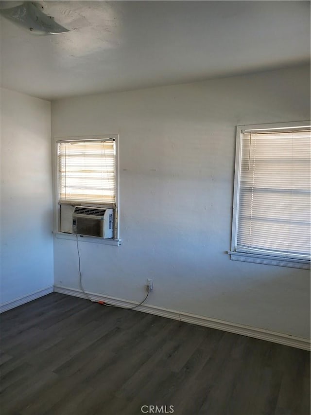 unfurnished room featuring dark hardwood / wood-style flooring and cooling unit