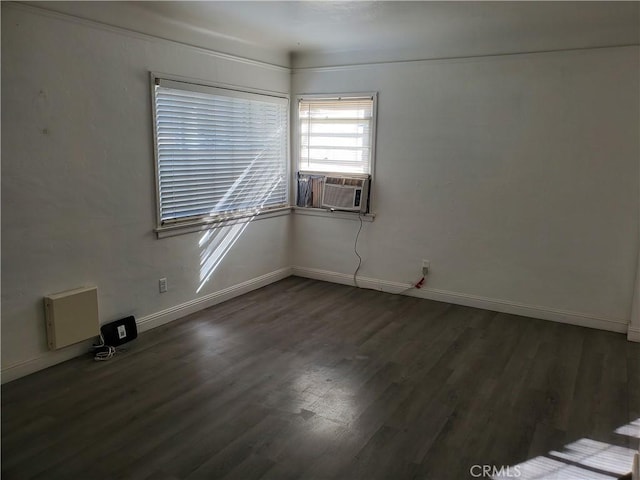 spare room featuring dark hardwood / wood-style floors and cooling unit