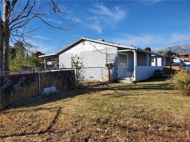 view of side of property with a yard