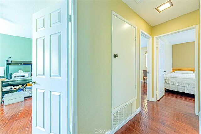 hall with wood-type flooring