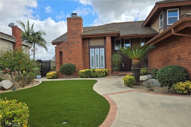 view of exterior entry with a yard