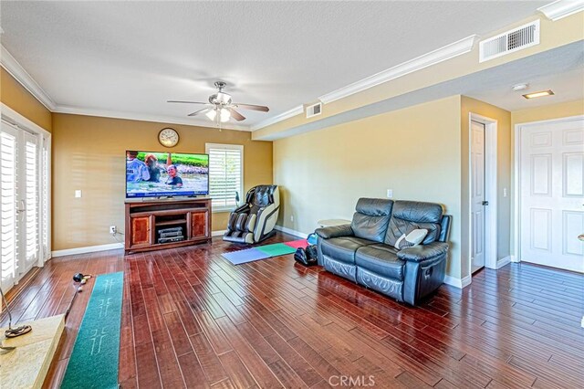 living room with a wealth of natural light, ornamental molding, and dark hardwood / wood-style floors