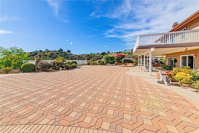 view of patio featuring a balcony