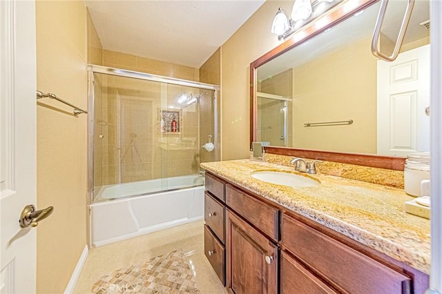 bathroom featuring vanity, tile patterned floors, and combined bath / shower with glass door