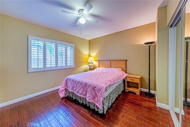 bedroom with ceiling fan and dark hardwood / wood-style floors