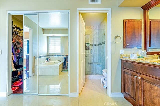 full bathroom with tile patterned flooring, vanity, and shower with separate bathtub