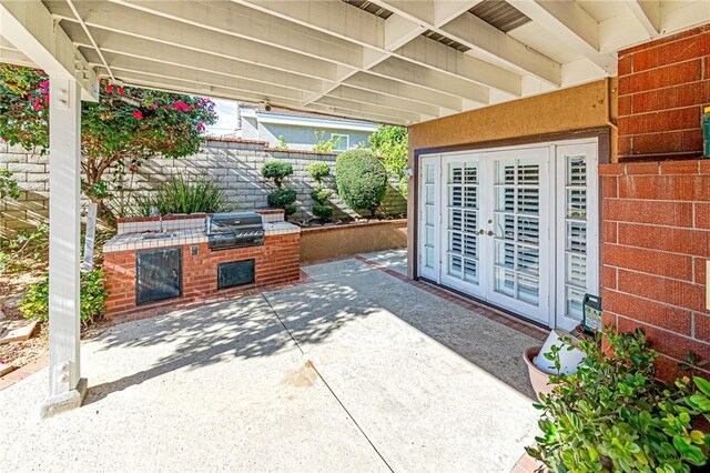 view of patio / terrace featuring french doors, area for grilling, and a grill