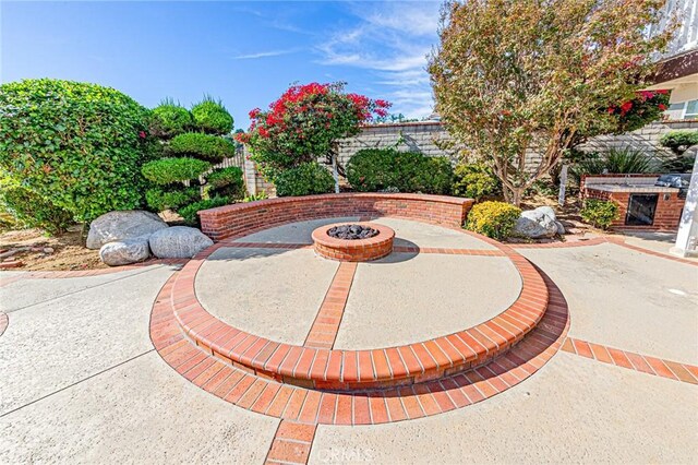 surrounding community featuring a patio and a fire pit