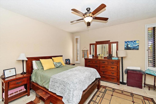 bedroom with ceiling fan and light tile patterned floors