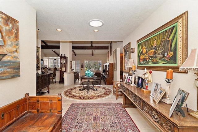 hall with beam ceiling, light tile patterned floors, and a textured ceiling