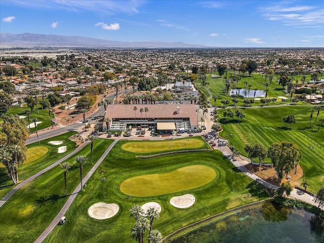 birds eye view of property with a water and mountain view