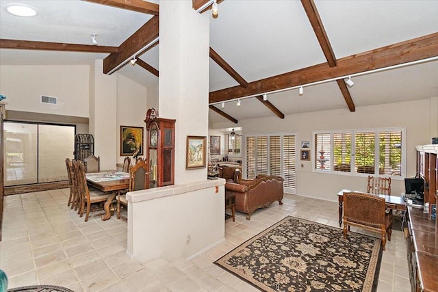 tiled living room featuring high vaulted ceiling, beamed ceiling, and track lighting