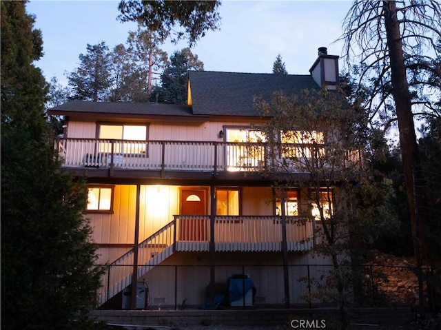 rear view of property with a wooden deck