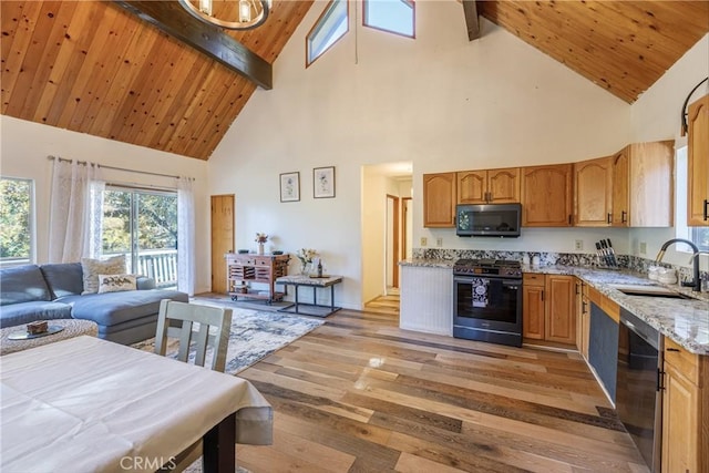 kitchen featuring high vaulted ceiling, black appliances, sink, light hardwood / wood-style floors, and beam ceiling