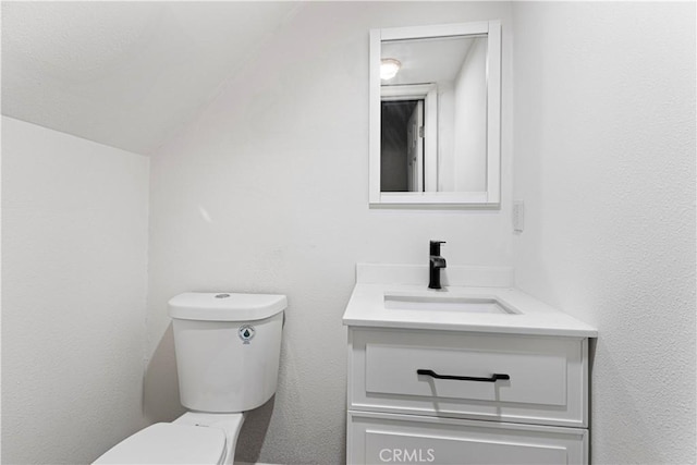 467 Cimarron Ln, Lake Arrowhead, CA 92352 - bathroom featuring toilet, vanity, and vaulted ceiling