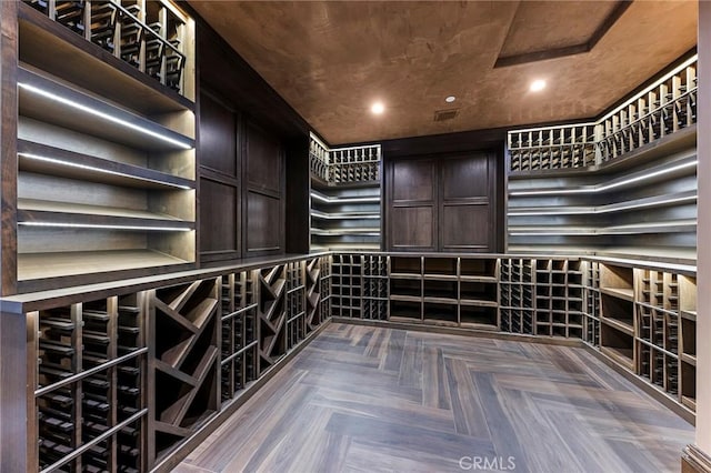 wine cellar with dark parquet flooring