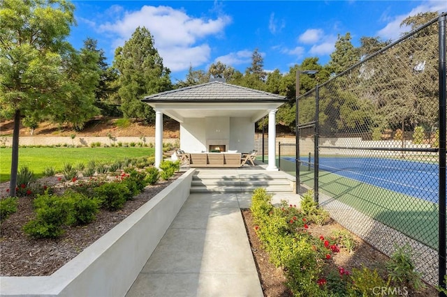 exterior space with a gazebo, an outdoor living space, and tennis court