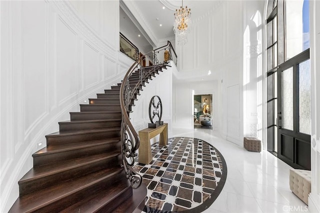 188 Deodar Ln, Bradbury, CA 91008 - tiled foyer entrance with a towering ceiling, a decorative wall, stairs, a chandelier, and recessed lighting