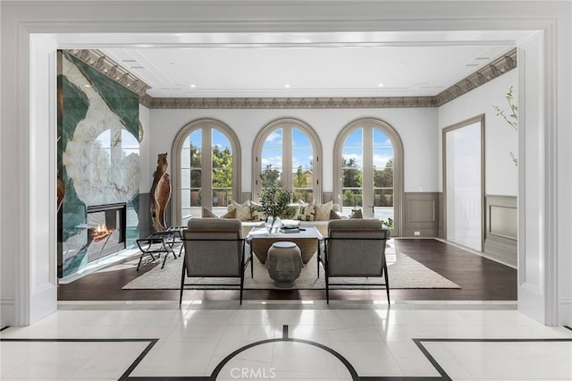 188 Deodar Ln, Bradbury, CA 91008 - living room featuring inlaid floor details, a high end fireplace, crown molding, and a wainscoted wall