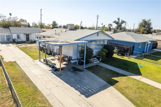 view of front of property with a patio and a front yard