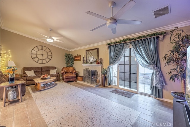 living room featuring hardwood / wood-style floors, ornamental molding, and ceiling fan