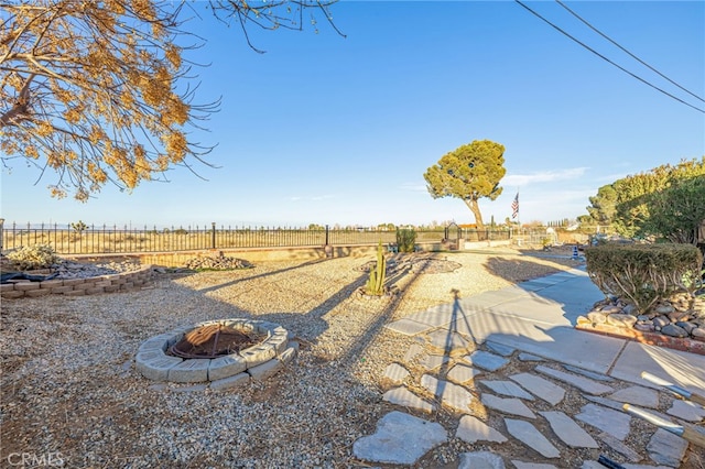 view of yard with a rural view and an outdoor fire pit