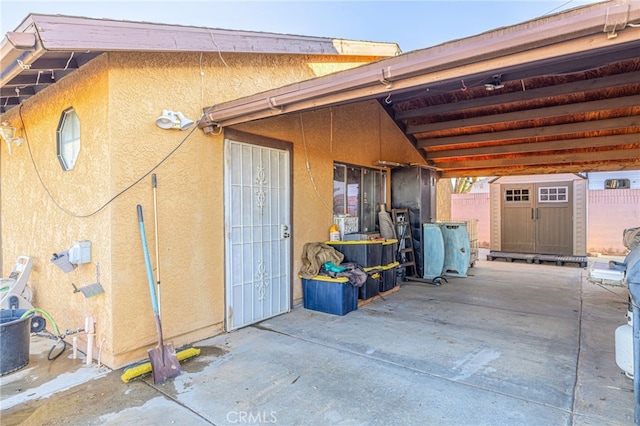 view of home's exterior with a storage shed and a patio