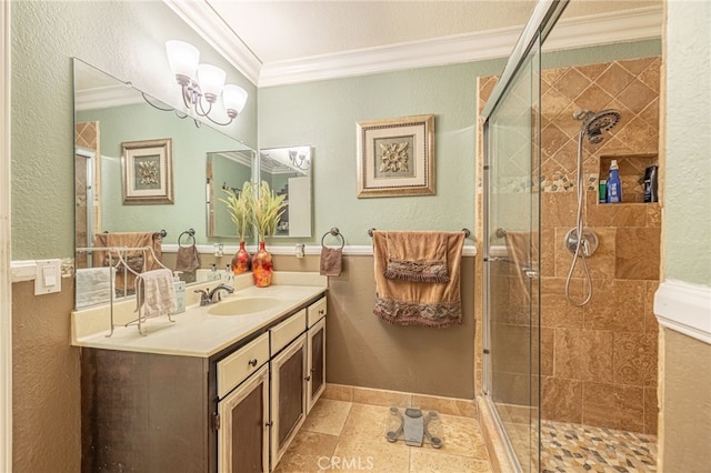 bathroom with vanity, crown molding, and a shower with door